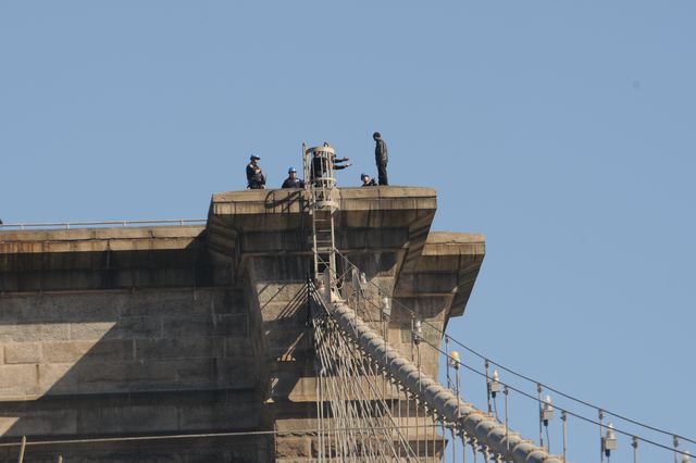 Officers confronting the man at the top of the bridge. (DCPI)